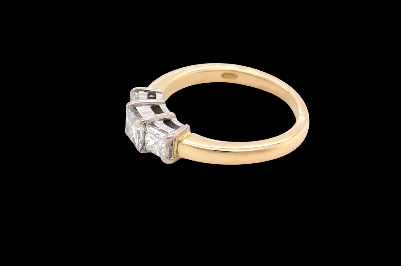 Gold ring with a diamond on a black background