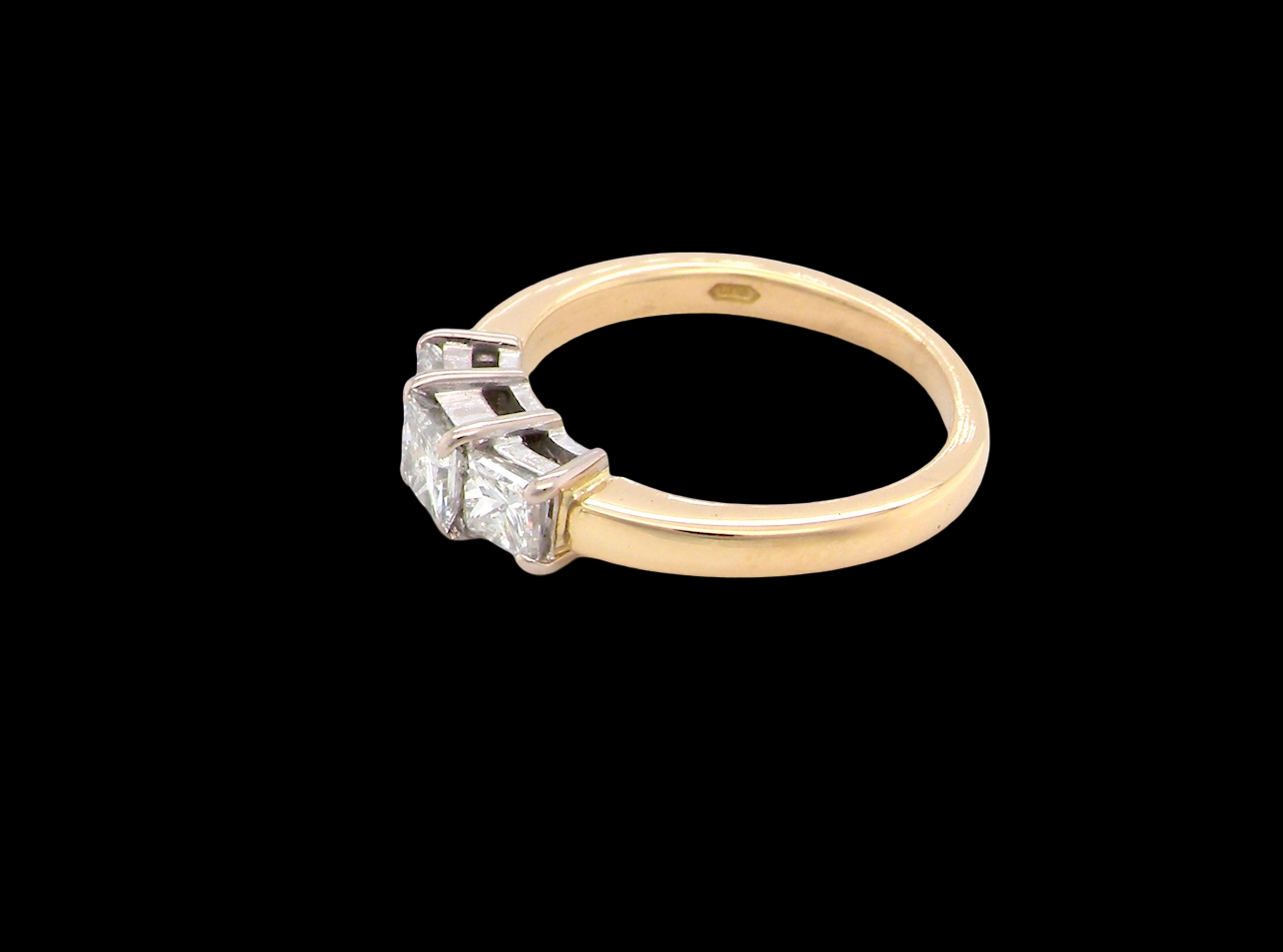Gold ring with a diamond on a black background