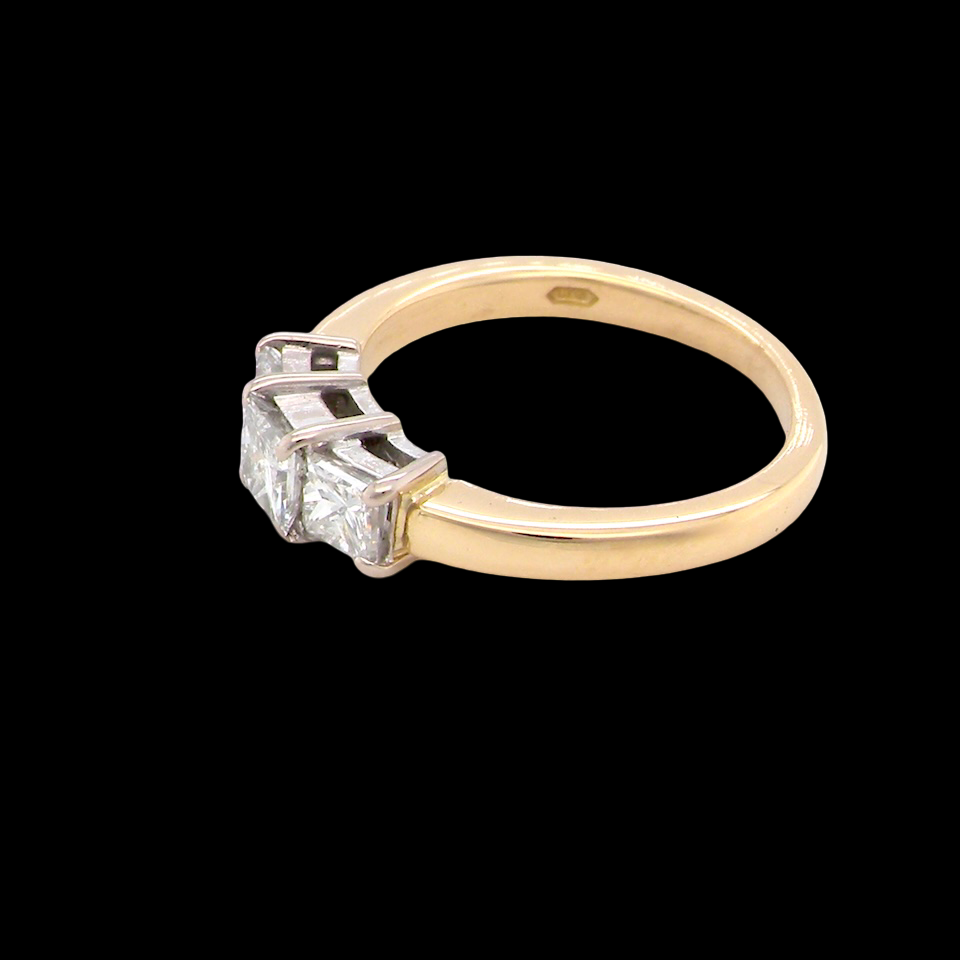 Gold ring with a diamond on a black background