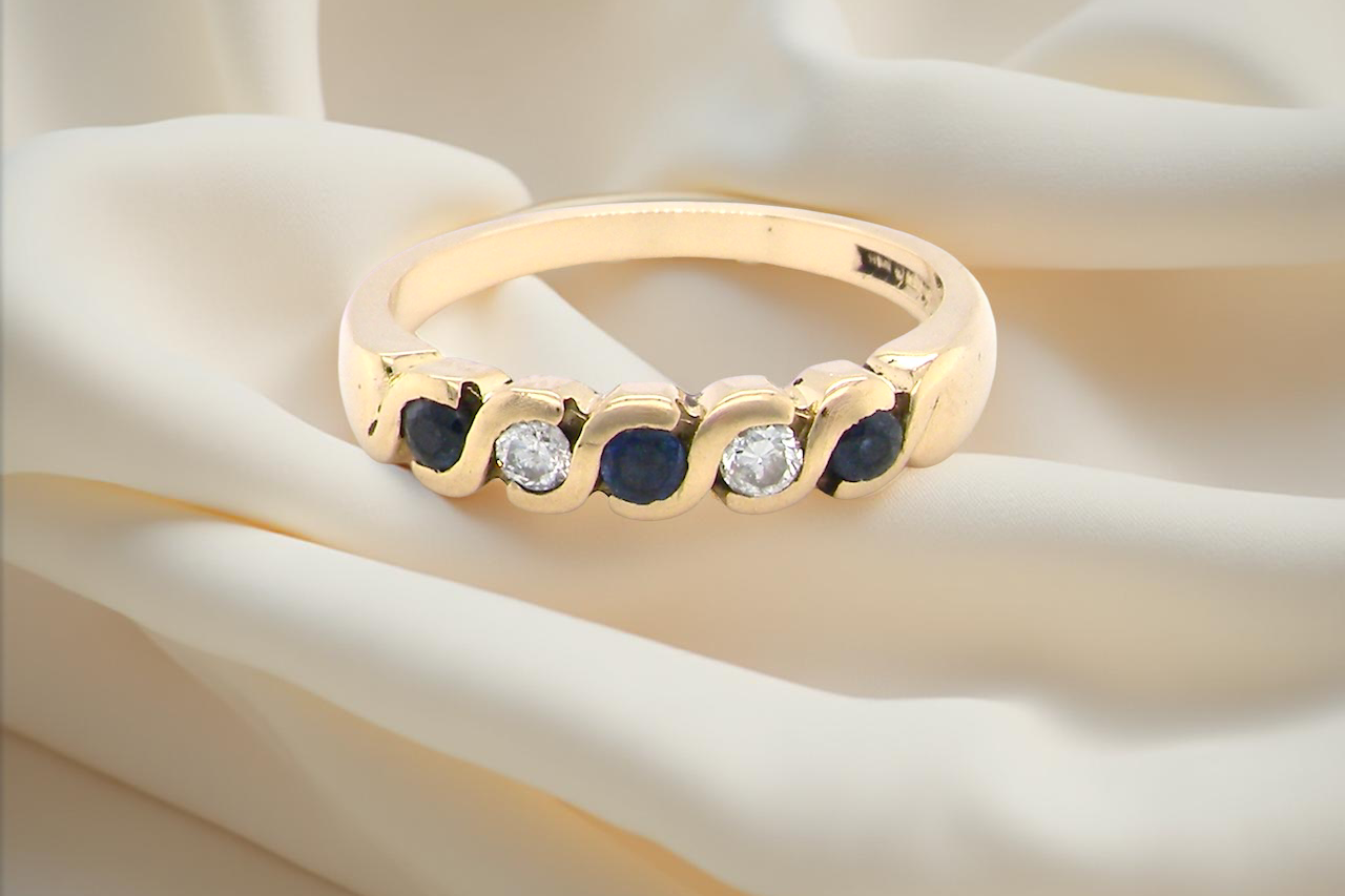 An 18 carat gold Sapphire and Diamond eternity ring