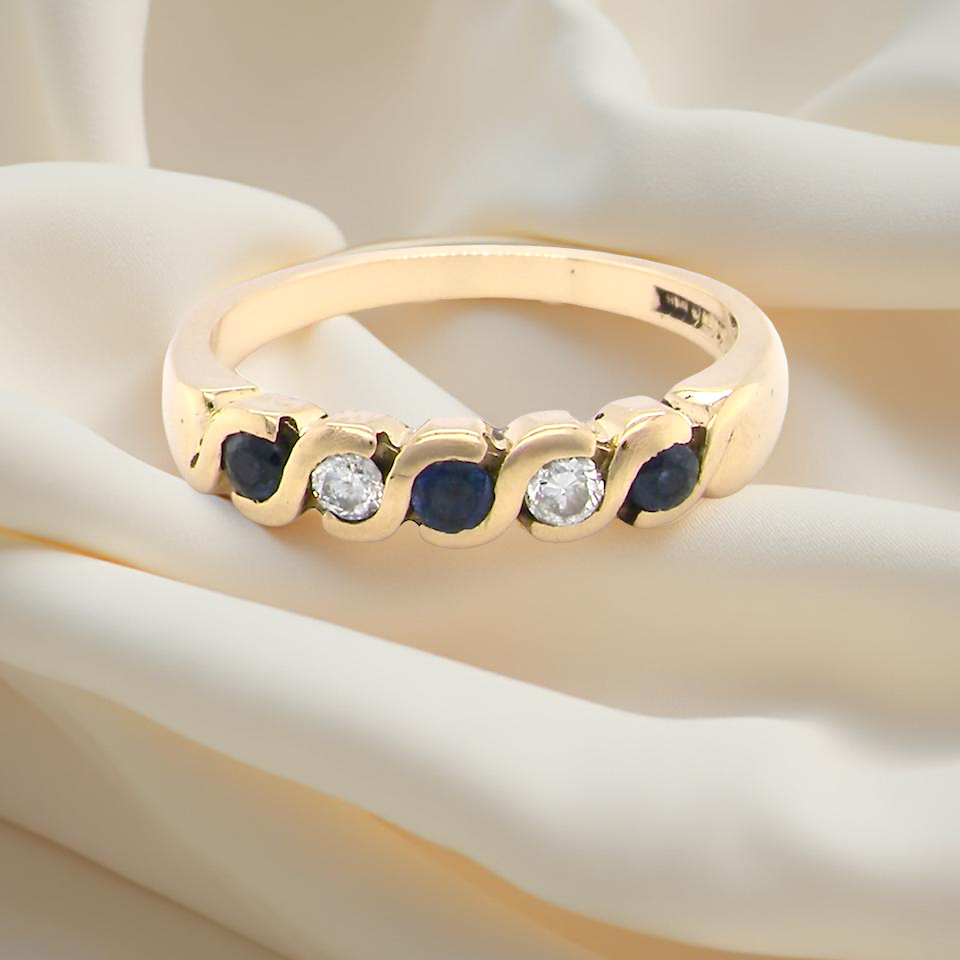 An 18 carat gold Sapphire and Diamond eternity ring