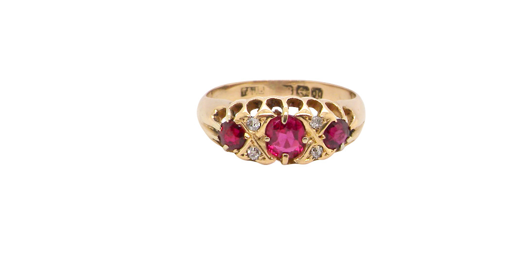 An 18 carat gold antique boat shaped ring. Features three lovely coloured wine red rubies, centre 5x4mm, each end 2.4mm.