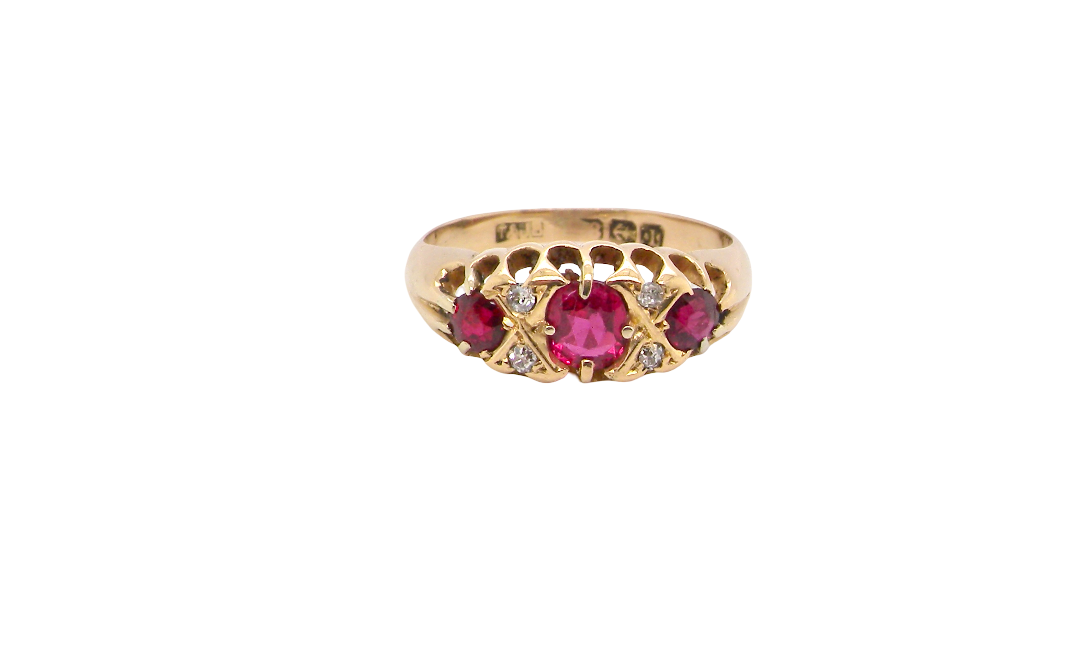 An 18 carat gold antique boat shaped ring. Features three lovely coloured wine red rubies, centre 5x4mm, each end 2.4mm.