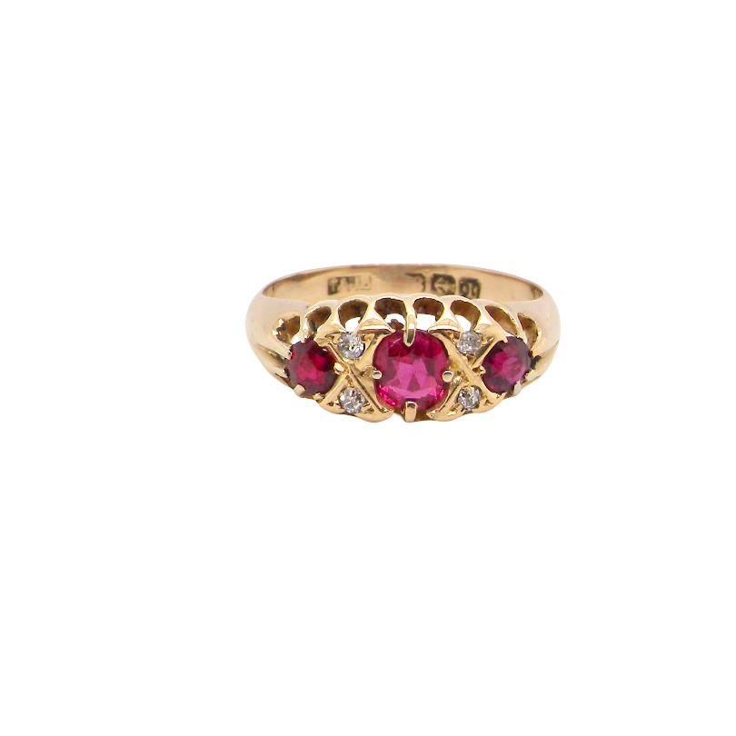 An 18 carat gold antique boat shaped ring. Features three lovely coloured wine red rubies, centre 5x4mm, each end 2.4mm.