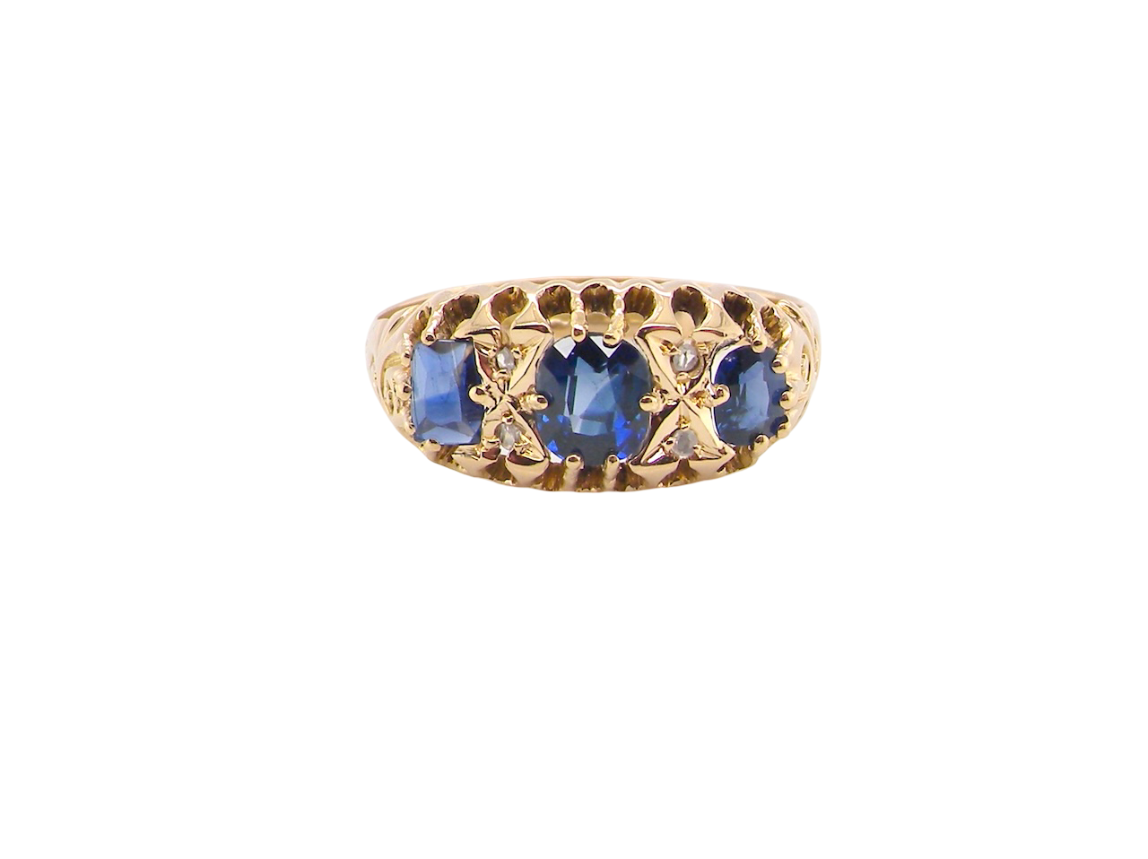 An 18 carat gold antique boat shaped ring. Features three oval to cushion cut sapphires, centre 6x5mm, each end 5x3mm. Mid to dark blue