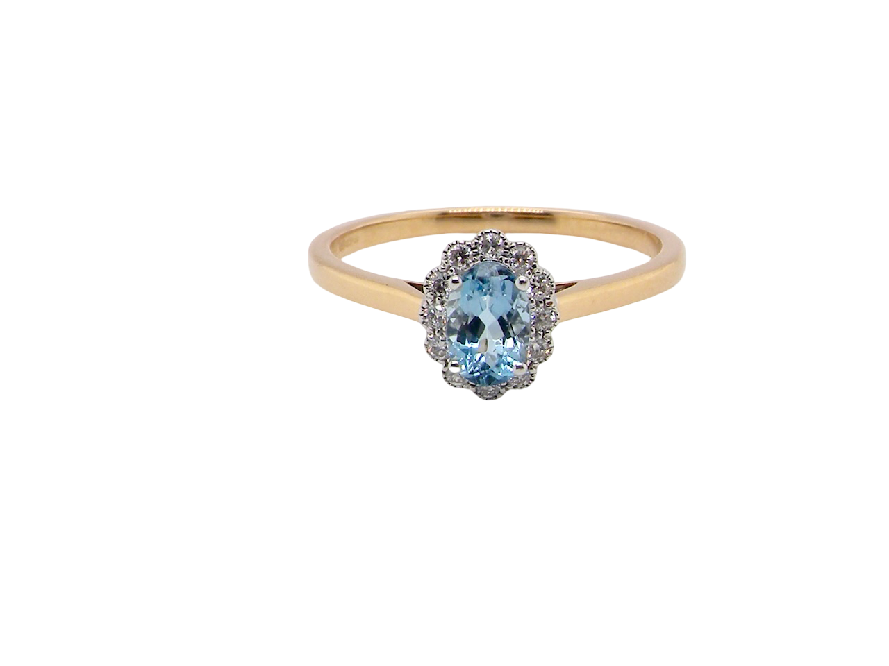 An 18 carat gold cluster ring. Set to the centre a lovely ice blue aquamarine 6x4mm, claw set.
