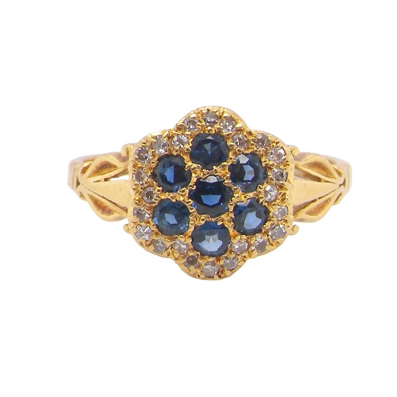 An 18 carat gold cluster ring. The centre a floral combination of seven sapphires,