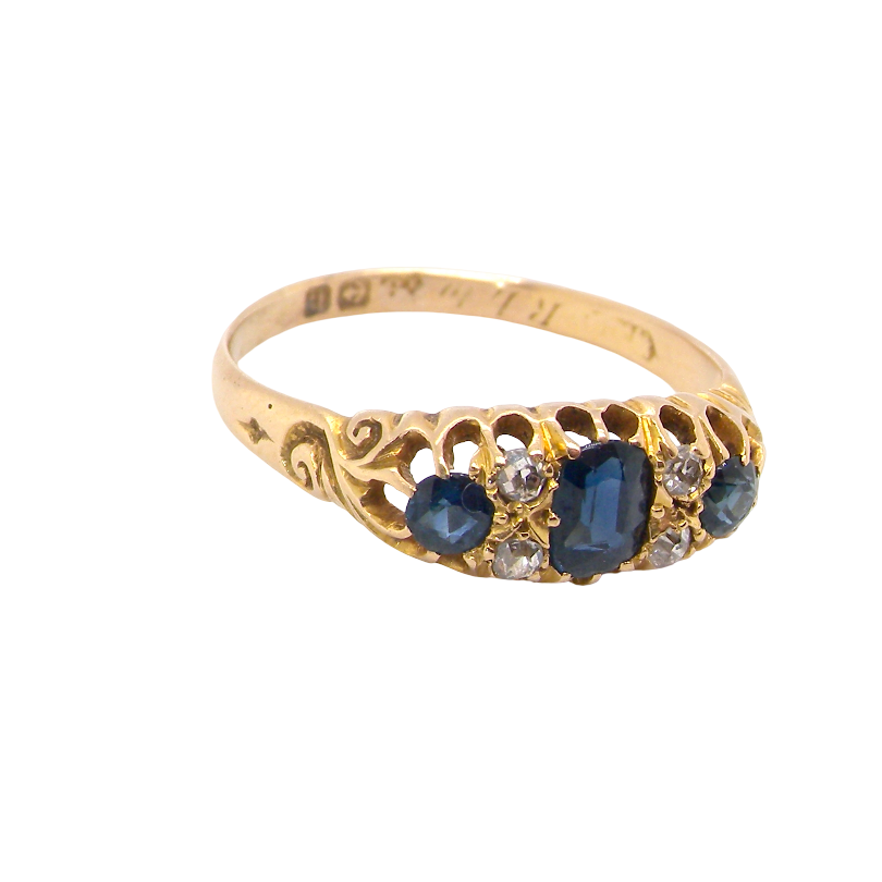 top side view An 18 carat gold early 20th century ring set with three sapphires. Centre 5x3.8mm each end 3.8x2.8mm.