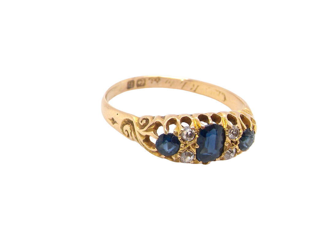 top side view An 18 carat gold early 20th century ring set with three sapphires. Centre 5x3.8mm each end 3.8x2.8mm.