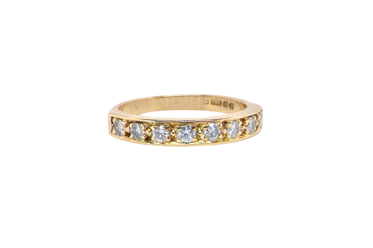 An 18 carat gold half-hoop eternity ring, set with eight brilliant-cut white diamonds