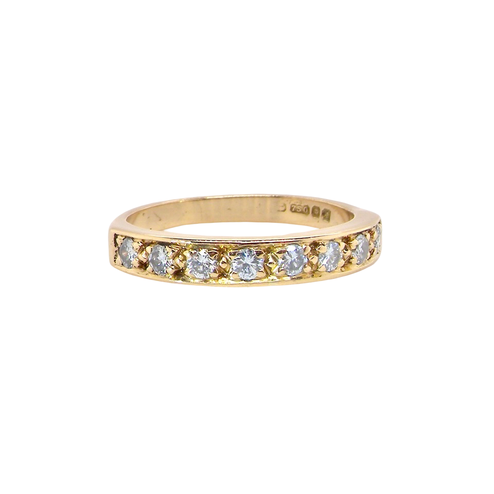 An 18 carat gold half-hoop eternity ring, set with eight brilliant-cut white diamonds