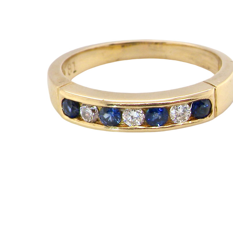 A yellow gold eternity-style ring featuring a row of round-cut blue sapphires and clear diamonds set in a channel, shown on a plain white background.