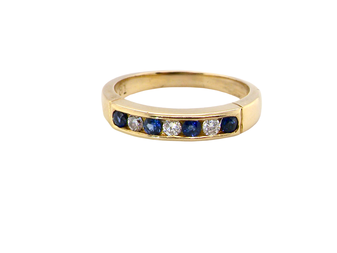 An 18 carat gold half hoop eternity ring.
Features four round sapphires , each 2.4mm,