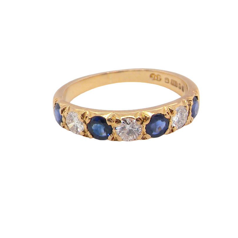An 18 carat gold half hoop eternity ring. Set with four sapphires each 3.4mm (0.15 carats) and three diamonds, brilliant cut, 3.4mm