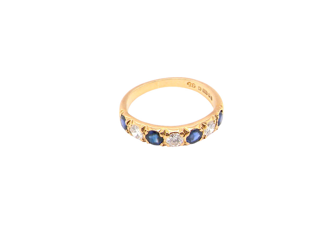 top An 18 carat gold half hoop eternity ring. Set with four sapphires each 3.4mm (0.15 carats) and three diamonds, brilliant cut, 3.4mm (0.15 carats).