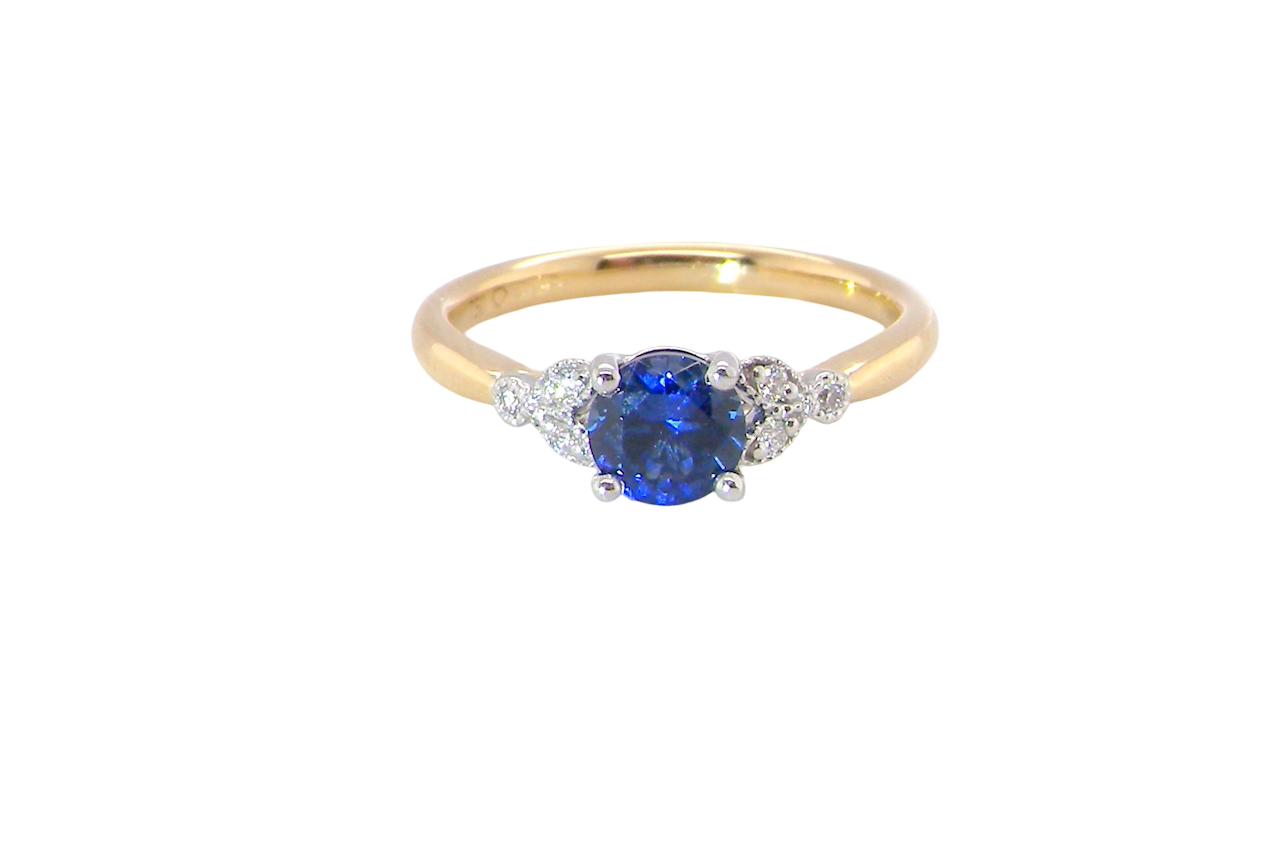 An 18 carat gold ring set with a vibrant blue sapphire,