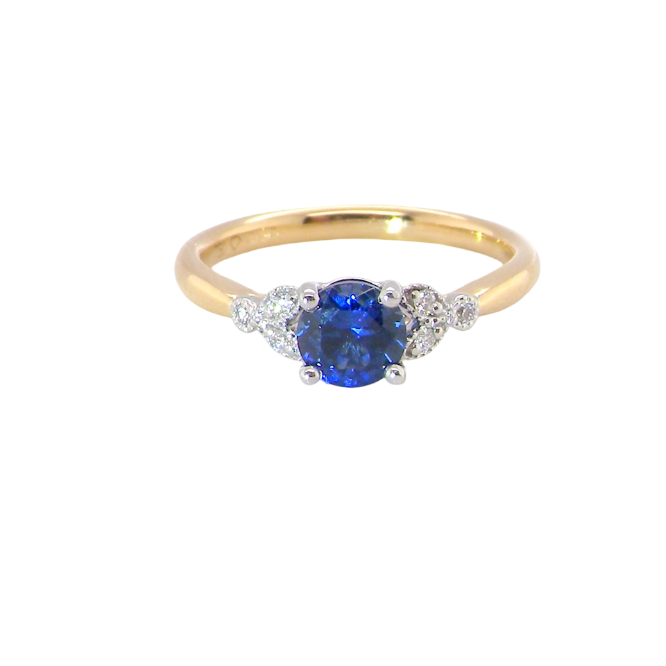 An 18 carat gold ring set with a vibrant blue sapphire,