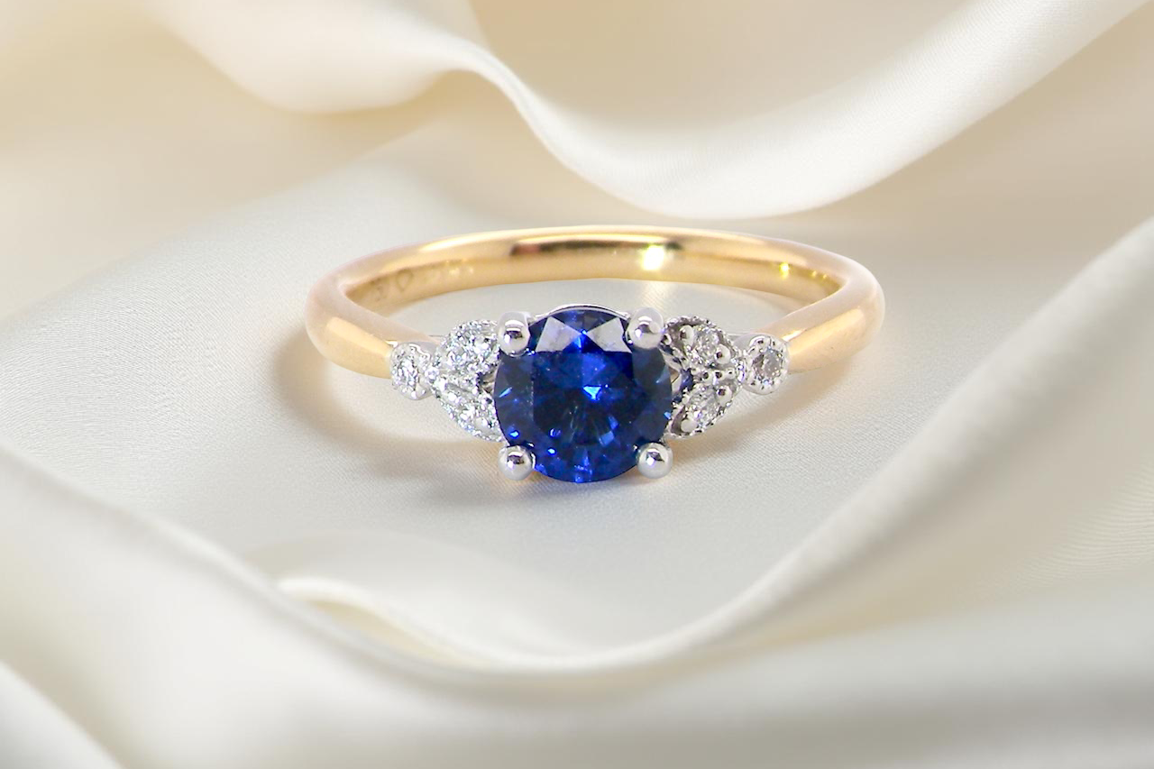 An 18 carat gold ring set with a vibrant blue sapphire, A