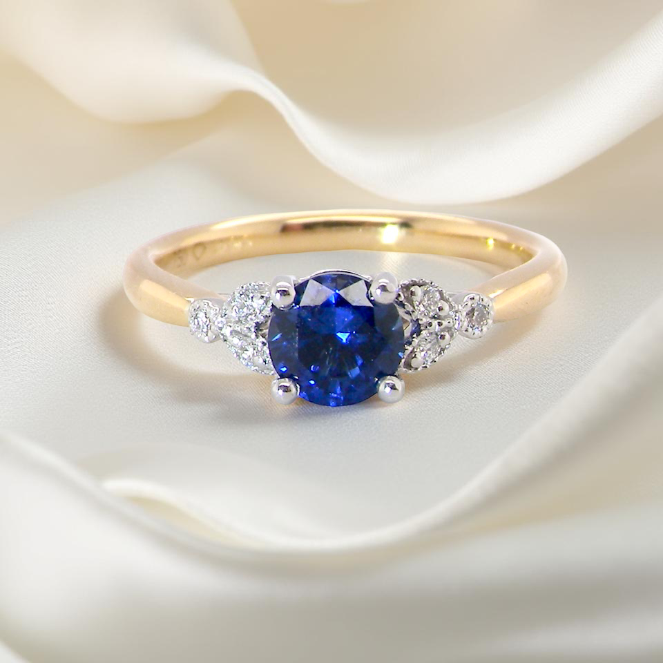 An 18 carat gold ring set with a vibrant blue sapphire, A