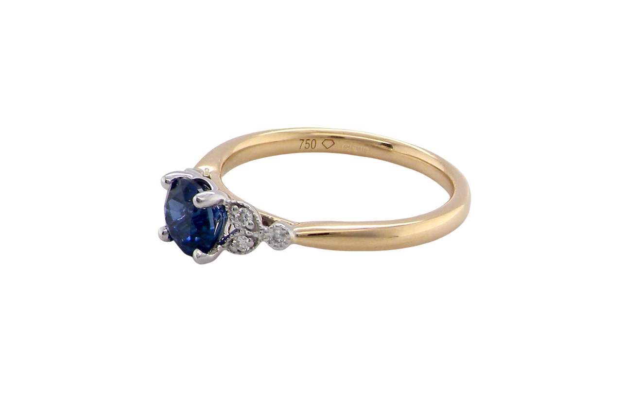 An 18 carat gold ring set with a vibrant blue sapphire, side