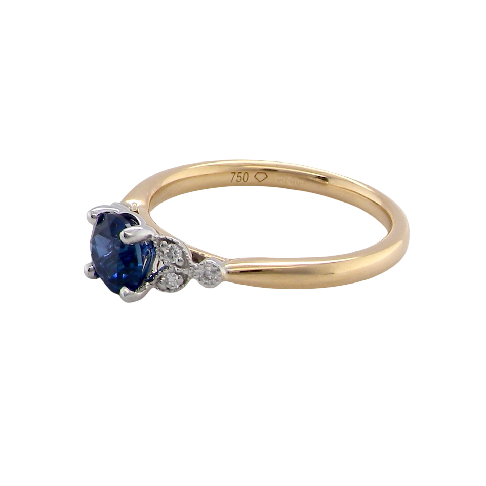 An 18 carat gold ring set with a vibrant blue sapphire, side