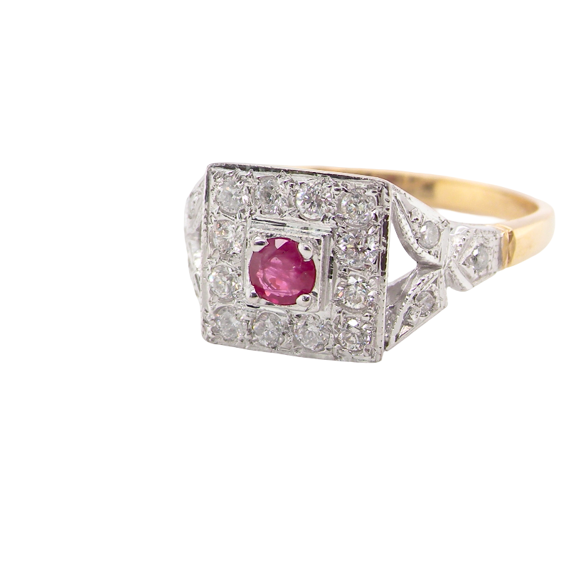 side view An 18 carat gold square cluster that features to the centre a round ruby and an outer halo of brilliant cut white diamonds.