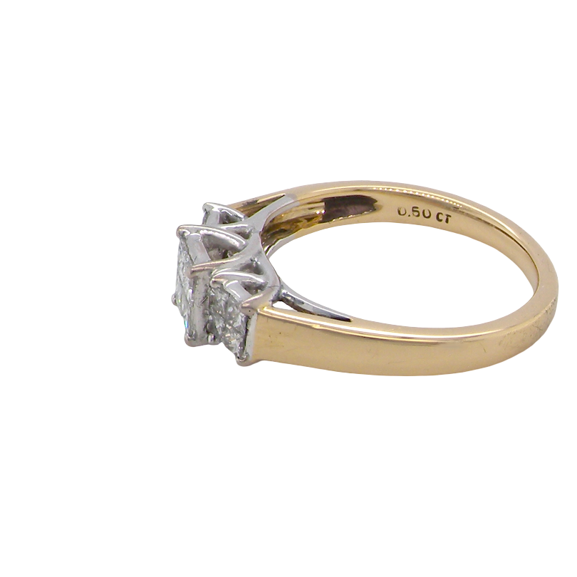 A two-tone diamond ring with a yellow gold band and a silver-colored setting featuring three marquise-cut diamonds, shown on a plain white background.