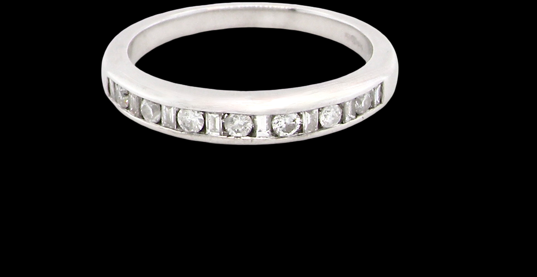 An 18 carat white gold half hoop eternity ring. Mixed cuts of white diamonds which consist of seven round brilliant stones, each 2mm diameter and eight baguette cut stones,