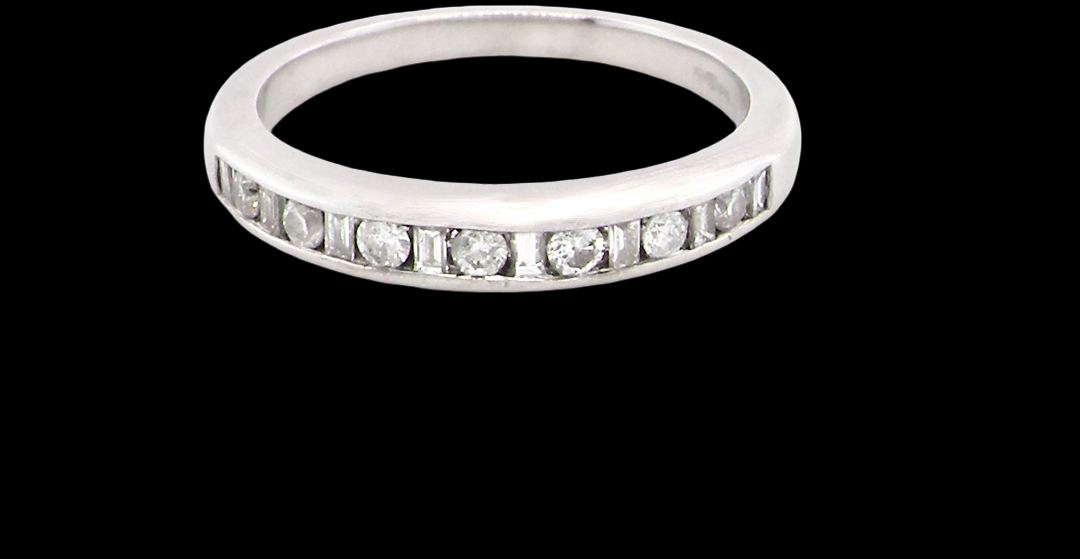 An 18 carat white gold half hoop eternity ring. Mixed cuts of white diamonds which consist of seven round brilliant stones, each 2mm diameter and eight baguette cut stones,