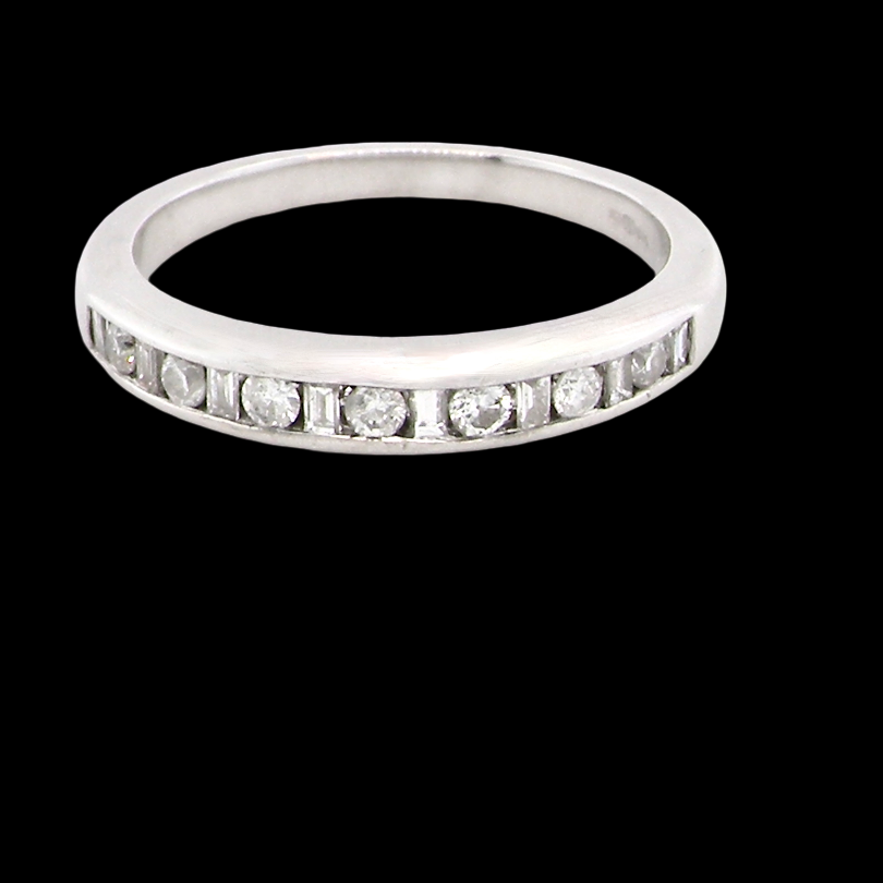 An 18 carat white gold half hoop eternity ring. Mixed cuts of white diamonds which consist of seven round brilliant stones, each 2mm diameter and eight baguette cut stones,