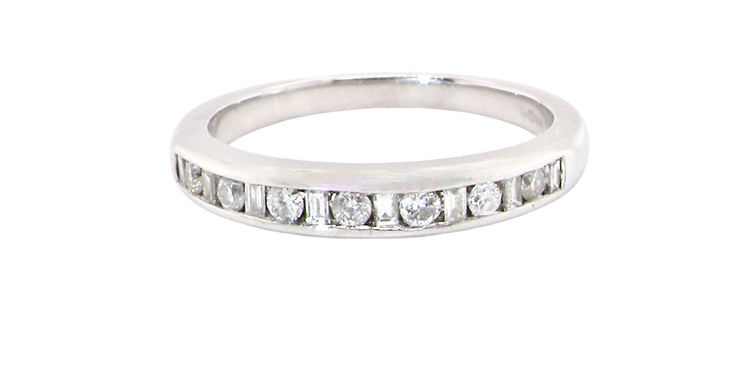 An 18 carat white gold half hoop eternity ring. Mixed cuts of white diamonds which consist of seven round brilliant stones, each 2mm diameter and eight baguette cut stones, each 2x1.5mm.