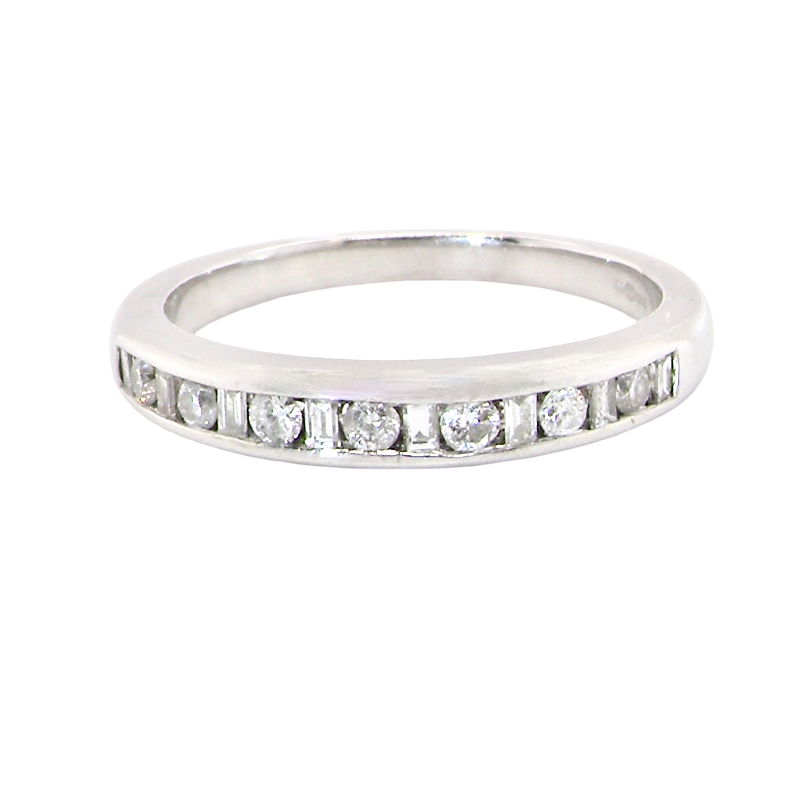 An 18 carat white gold half hoop eternity ring. Mixed cuts of white diamonds which consist of seven round brilliant stones, each 2mm diameter and eight baguette cut stones, each 2x1.5mm.
