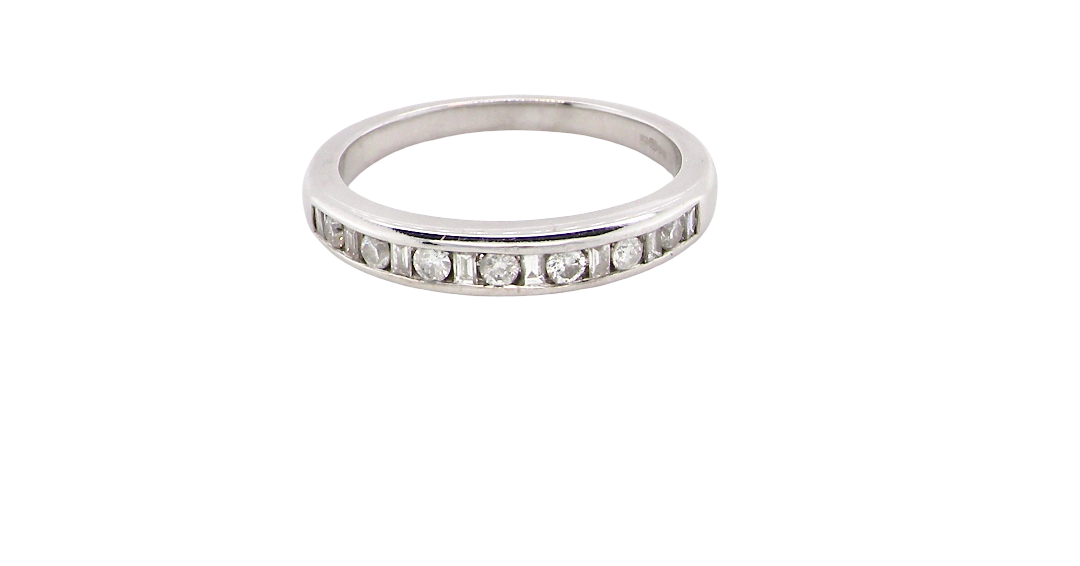 An 18 carat white gold half hoop eternity ring. Mixed cuts of white diamonds which consist of seven round brilliant stones, each 2mm diameter and eight baguette cut stones, each 2x1.5mm. Estimated total 0.50 carats.