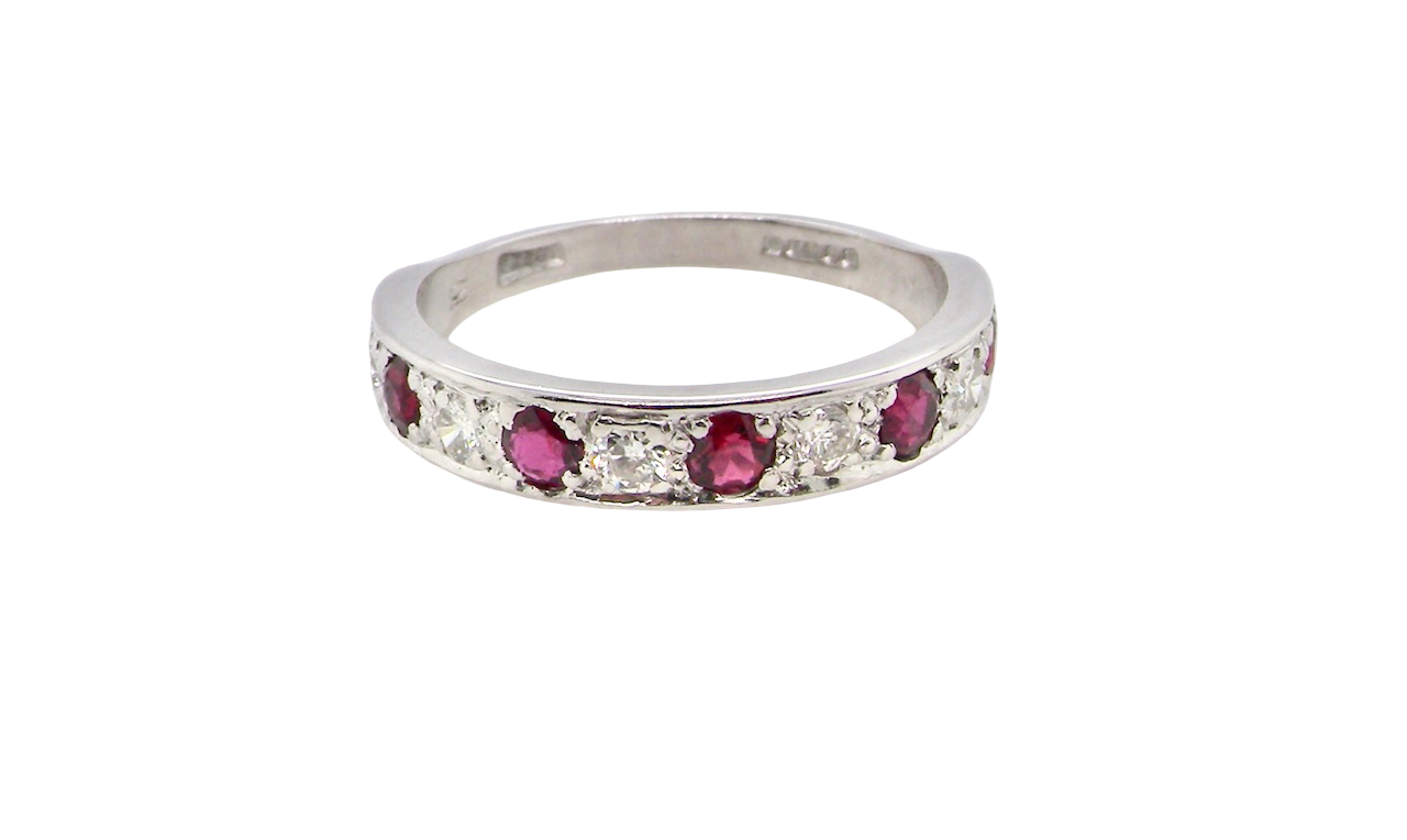 An 18 carat white gold half hoop eternity ring. Set with five round 3mm rubies (est 0.50 carats) 