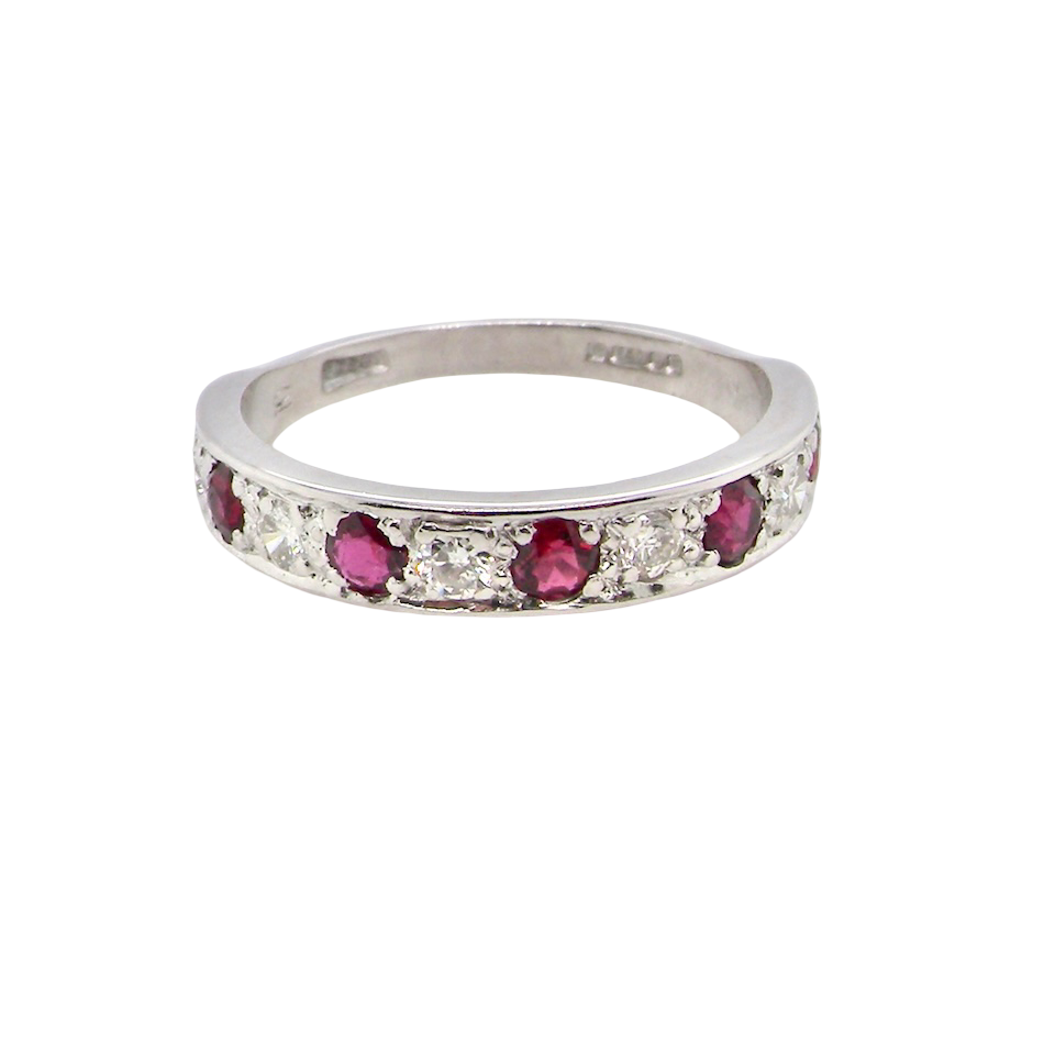 An 18 carat white gold half hoop eternity ring. Set with five round 3mm rubies (est 0.50 carats) 
