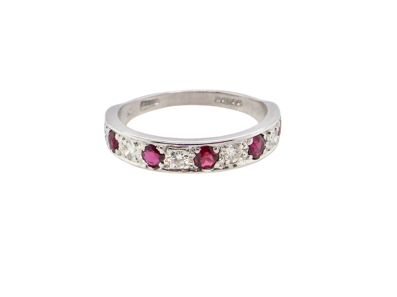 An 18 carat white gold half hoop eternity ring. Set with five round 3mm rubies (est 0.50 carats) 