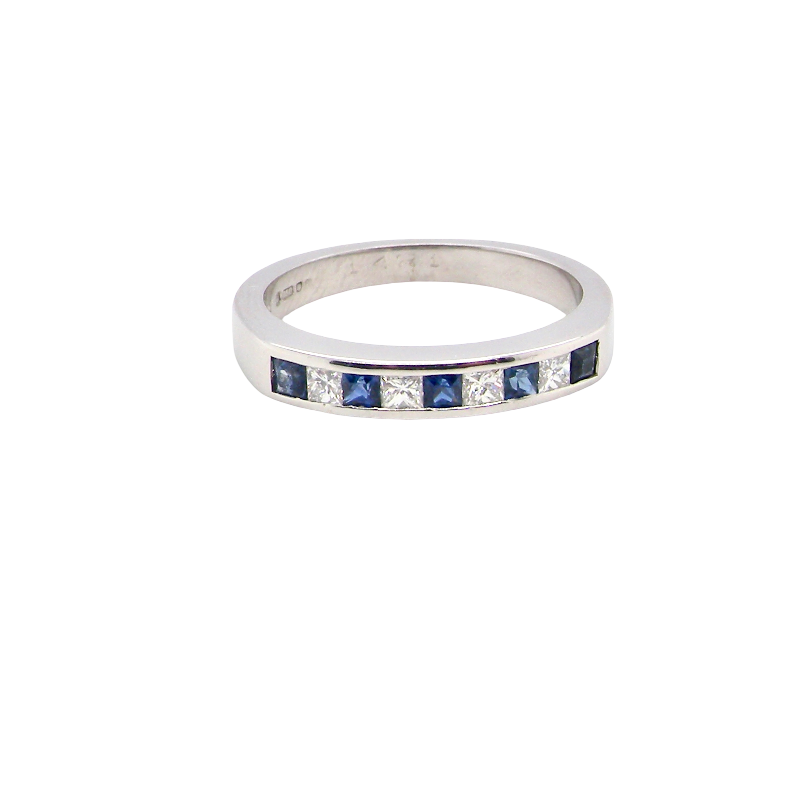 An 18 carat white gold half hoop eternity ring. Set with princess cut white diamonds, total of four- estimated 0.40 carats (2.4mm each) colour H-j, clarity Si.