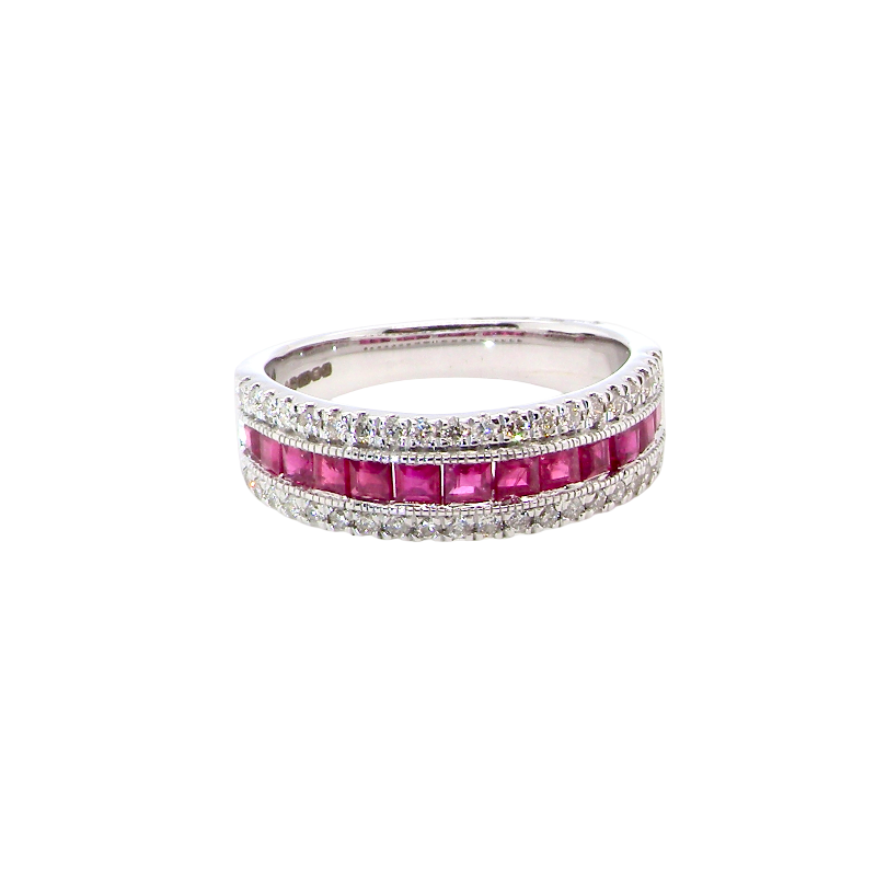 An 18 carat white gold half hoop ring. A triple row design with a line of channel set calibre cut rubies running along the centre , to a total carat weight of 0.97 carats.