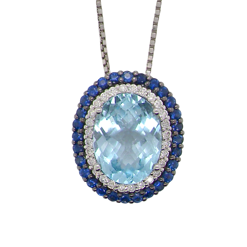 An oval pendant necklace featuring a large light blue topaz center stone, surrounded by a halo of small white stones and a border of deep blue sapphires, suspended on a silver-toned chain against a plain white background.