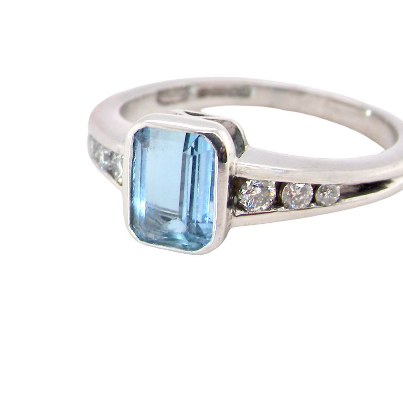 An 18 carat white gold ring, features a rectangular step cut aquamarine, measures 7x5mm (st one carat) sky blue,