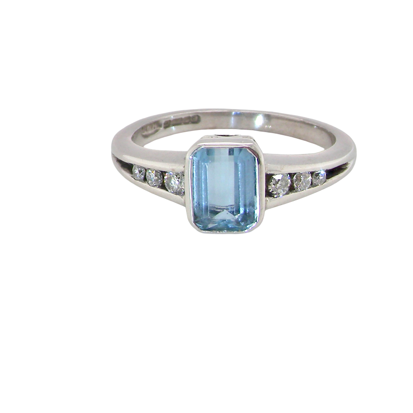 An 18 carat white gold ring, features a rectangular step cut aquamarine, measures 7x5mm (st one carat) sky blue, fine clarity. Rim setting.
