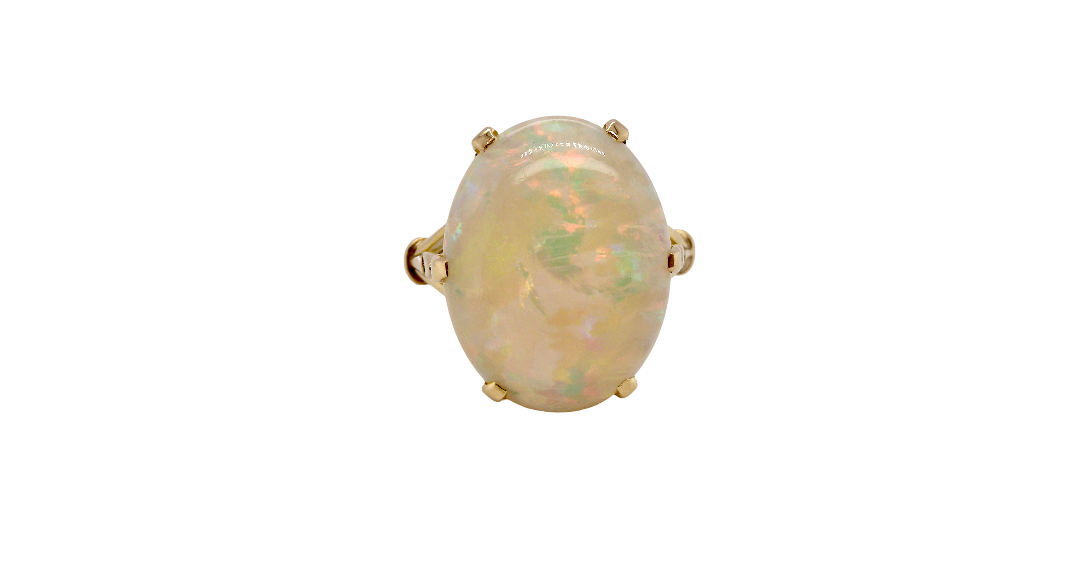 An 18 carat yellow gold* dress ring set with a large opal gemstone.