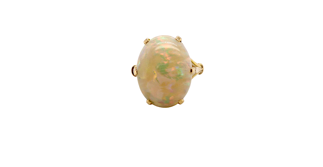 An 18 carat yellow gold* dress ring set with a large oval opal gemstone.
