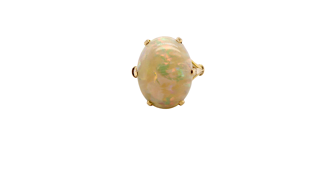 An 18 carat yellow gold* dress ring set with a large oval opal gemstone.