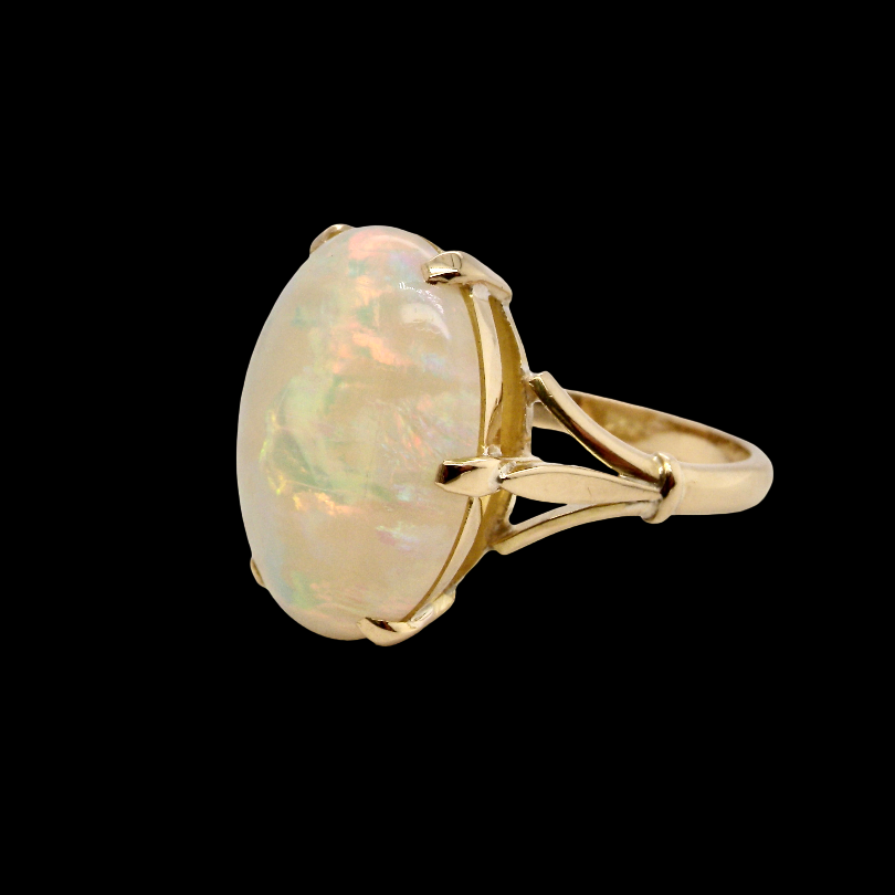 An 18 carat yellow gold* dress ring set with a large oval opal gemstone. side