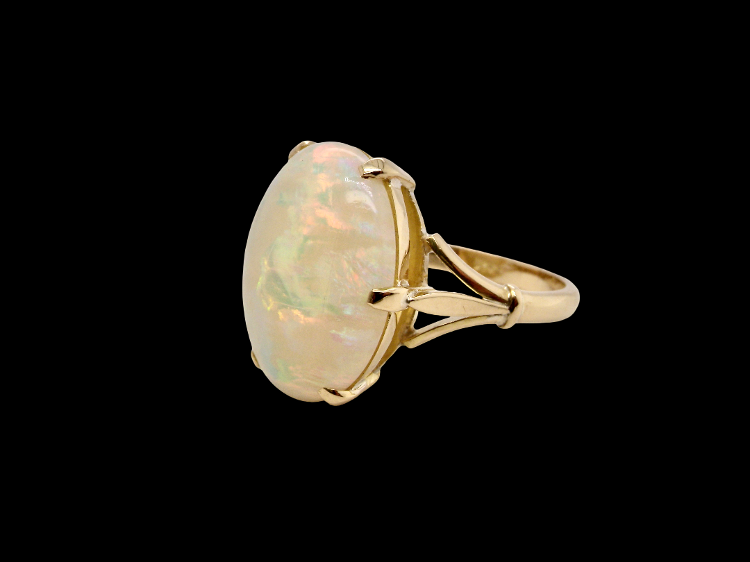 An 18 carat yellow gold* dress ring set with a large oval opal gemstone. side