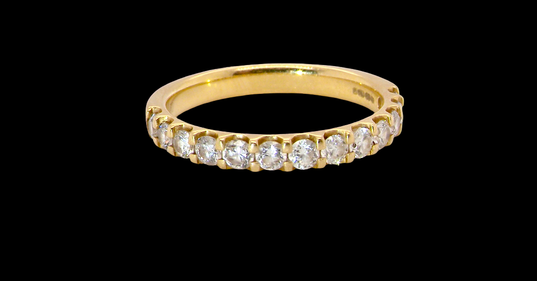 An 18 carat yellow gold half hoop diamond eternity ring originally purchased from Goldsmiths