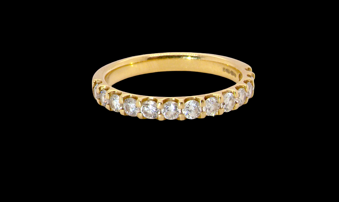 An 18 carat yellow gold half hoop diamond eternity ring originally purchased from Goldsmiths