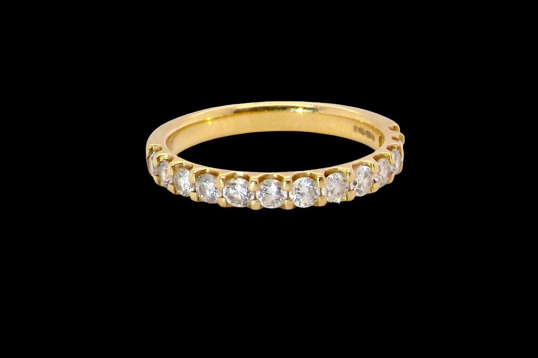 An 18 carat yellow gold half hoop diamond eternity ring originally purchased from Goldsmiths