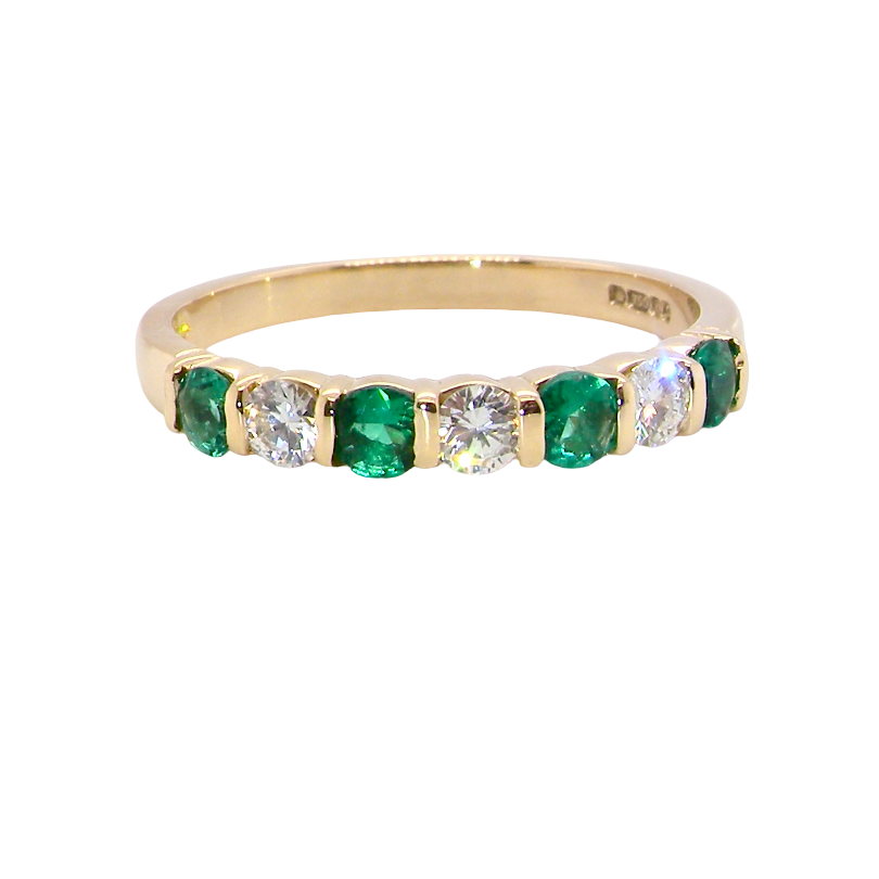 An 18 carat yellow gold half hoop eternity ring. Set with four bright green emeralds, each 3mm diameter .
